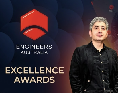 Arash, Founder of Your Next Job AU, standing next to Engineers Australia Excellence Awards logo